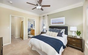 Cornelius apartment for rent - A bedroom with a bed, nightstand, and a ceiling fan.