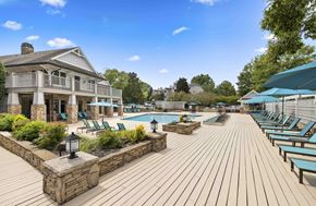 Charlotte apartment for rent - A wooden deck with a pool and lounge chairs.
