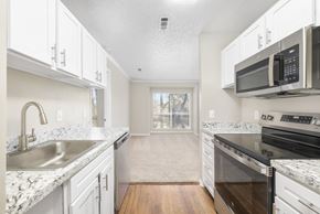 Glen Allen apartment for rent - A kitchen with white cabinets and granite countertops.