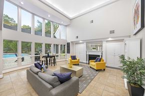 Midlothian apartment for rent - A living room with a grey couch, yellow chairs, and a fireplace.