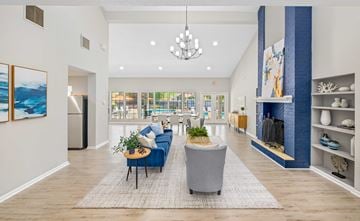 Hampton apartment for rent - A living room with a blue couch and a grey armchair.