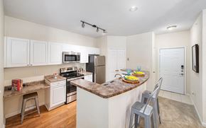 Chesapeake apartment for rent - a kitchen with an island and a counter with bar stools