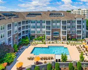 Charlottesville apartment for rent - an aerial view of a swimming pool in front of an apartment building