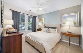 Charlottesville apartment for rent - a bedroom with a large bed and a ceiling fan