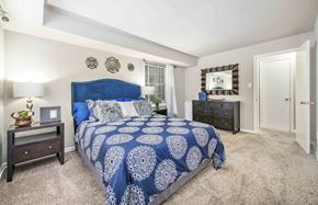 Fredericksburg apartment for rent - A bedroom with a blue bedspread and a white patterned bedspread.