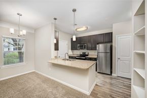 Fredericksburg apartment for rent - A kitchen with a stove top oven and a refrigerator.