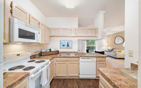 Charlotte apartment for rent - a kitchen with white appliances and wooden cabinets