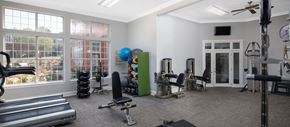 Charlotte apartment for rent - a gym with weights and cardio equipment in a room with windows