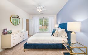 Charlotte apartment for rent - a bedroom with a bed and a ceiling fan