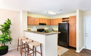 Matthews apartment for rent - a kitchen with a counter with three bar stools