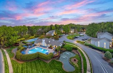 Matthews apartment for rent - A beautiful aerial view of a resort with a swimming pool and a winding river.