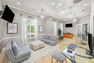Matthews apartment for rent - A modern living room with a grey sofa set, a glass coffee table, and a television.