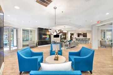 Charlotte apartment for rent - a living room with blue chairs and a table
