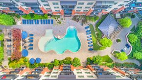 Charlotte apartment for rent - an aerial view of a swimming pool in front of an apartment building