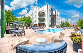 Charlotte apartment for rent - A sunny day at a poolside with a building in the background.