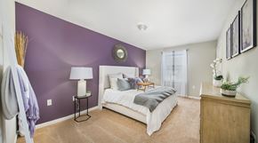 Raleigh apartment for rent - a bedroom with a white bed and purple accent wall