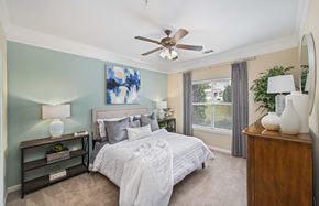 Raleigh apartment for rent - a bedroom with a bed and a ceiling fan