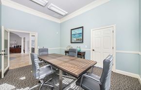 Raleigh apartment for rent - a conference room with blue walls and a wooden table and chairs