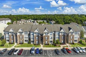 Apex apartment for rent - an aerial view of an apartment building with parking lot and cars