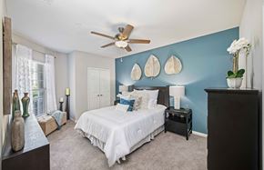 Apex apartment for rent - a bedroom with a bed and a ceiling fan