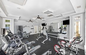 Apex apartment for rent - a gym with a lot of exercise equipment and windows