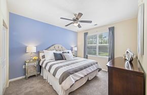 Raleigh apartment for rent - a bedroom with a bed and a ceiling fan