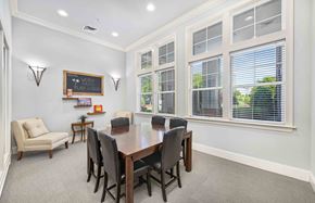 Raleigh apartment for rent - a dining room with a table and chairs in front of windows