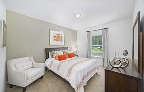 Cary apartment for rent - a bedroom with a bed and a chair