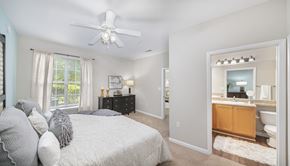 Raleigh apartment for rent - a bedroom with a bed and a ceiling fan