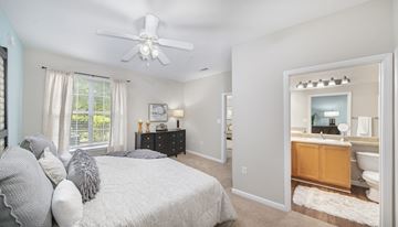 Raleigh apartment for rent - a bedroom with a bed and a ceiling fan