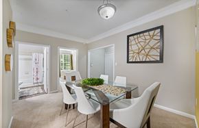 Raleigh apartment for rent - a dining room with a glass table and white chairs