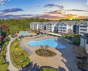 Raleigh apartment for rent - an aerial view of an outdoor pool and resort building with trees