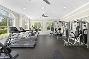 Raleigh apartment for rent - A spacious gym with treadmills, elliptical machines, and weight machines.