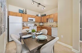 Raleigh apartment for rent - A kitchen with a table and chairs in the middle.