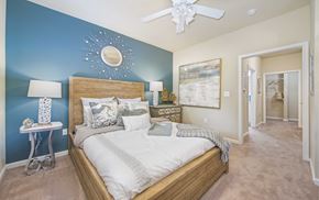 Raleigh apartment for rent - a bedroom with a bed and a ceiling fan
