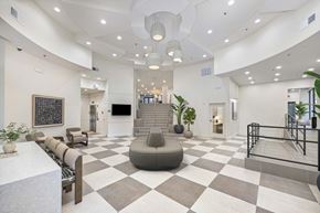 Raleigh apartment for rent - A spacious lobby with a checkered floor and a variety of seating options.