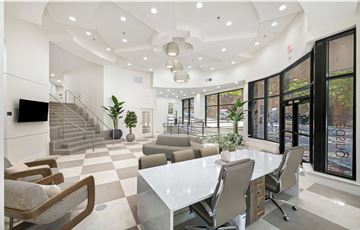 Raleigh apartment for rent - A modern living room with a white dining table and chairs.