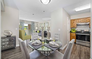Nashville apartment for rent - a dining room with a glass table and chairs and a living room with an oven