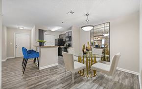 Nashville apartment for rent - an open kitchen and dining room with a glass table and chairs