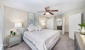 Nashville apartment for rent - a bedroom with a large bed and a ceiling fan