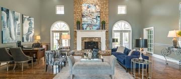 Nashville apartment for rent - a living room with blue furniture and a brick fireplace
