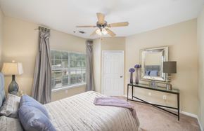 Hendersonville apartment for rent - a bedroom with a large bed and a ceiling fan