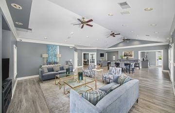 Hendersonville apartment for rent - a living room with couches and chairs and a dining room