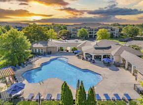 Gallatin apartment for rent - an aerial view of a swimming pool with umbrellas at sunset