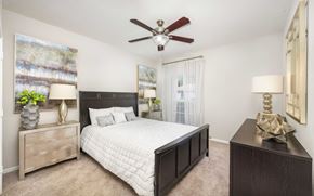 Hendersonville apartment for rent - a bedroom with a bed and a ceiling fan