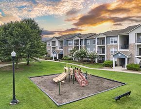 Hendersonville apartment for rent - a playground at the preserve at sunset in front of an apartment building