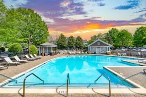 Franklin apartment for rent - A large swimming pool surrounded by lounge chairs and trees.