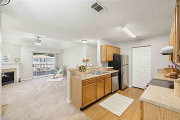 Murfreesboro apartment for rent - A kitchen with wooden cabinets and a black refrigerator.