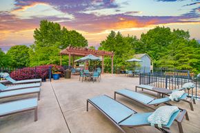 Chattanooga apartment for rent - an outdoor patio with tables and chairs and a gazebo at sunset