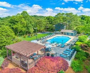 Chattanooga apartment for rent - an aerial view of a swimming pool and patio with chairs